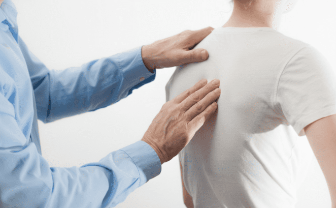 examining upper back - mild scoliosis